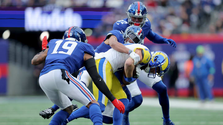 Dec 31, 2023; East Rutherford, New Jersey, USA; Los Angeles Rams wide receiver Cooper Kupp (10) is tackled by New York Giants cornerback Nick McCloud (44) and safeties Jason Pinnock (27) and Isaiah Simmons (19) during the first quarter at MetLife Stadium.  