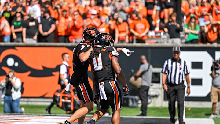 Sep 14, 2024; Corvallis, Oregon, USA; Oregon State Beavers wide receiver Trent Walker (7) celebrates a touchdown by running back Anthony Hankerson (0) during the second quarter against the Oregon Ducks at Reser Stadium. Mandatory Credit: Craig Strobeck-Imagn Images