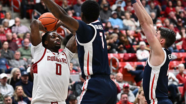 Jan 15, 2026; Pullman, Washington, USA; Washington State Cougars forward Emmanuel Ugbo (0) passes the ball against Gonzaga Bulldogs guard Tyon Grant-Foster (7) in the first half at Friel Court at Beasley Coliseum. Mandatory Credit: James Snook-Imagn Images