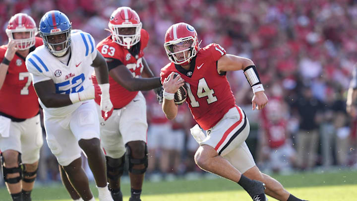 Oct 18, 2025; Athens, Georgia, USA; Georgia Bulldogs quarterback Gunner Stockton (14) runs the ball for a touchdown against Mississippi Rebels defensive tackle Will Echoles (52) during the first half of the game at Sanford Stadium. Mandatory Credit: Dale Zanine-Imagn Images Oct 18, 2025; Athens, Georgia, USA; Georgia Bulldogs quarterback Gunner Stockton (14) runs the ball for a touchdown against Mississippi Rebels defensive tackle Will Echoles (52) during the first half of the game at Sanford Stadium. Mandatory Credit: Dale Zanine-Imagn Images