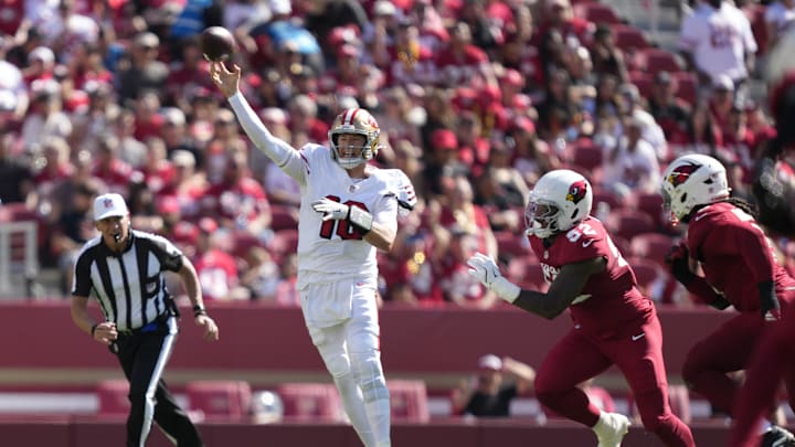 Sep 21, 2025; Santa Clara, California, USA; San Francisco 49ers quarterback Mac Jones (10) throws downfield as Arizona Cardinals linebacker Jordan Burch (52) defends during the second half at Levi's Stadium. Mandatory Credit: Kyle Terada-Imagn Images Sep 21, 2025; Santa Clara, California, USA; San Francisco 49ers quarterback Mac Jones (10) throws downfield as Arizona Cardinals linebacker Jordan Burch (52) defends during the second half at Levi's Stadium. Mandatory Credit: Kyle Terada-Imagn Images