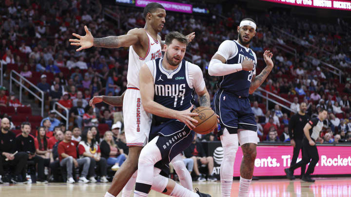 Mar 31, 2024; Houston, Texas, USA; Dallas Mavericks guard Luka Doncic (77) grabs a rebound away from Mar 31, 2024; Houston, Texas, USA; Dallas Mavericks guard Luka Doncic (77) grabs a rebound away from
