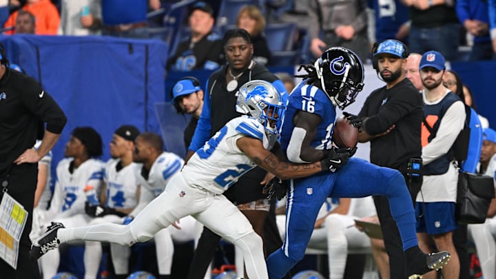 Nov 24, 2024; Indianapolis, Indiana, USA; Indianapolis Colts wide receiver Ashton Dulin (16) catches a pass which is called incomplete under coverage from Detroit Lions cornerback Kindle Vildor (29) during the second half at Lucas Oil Stadium. Mandatory Credit: Marc Lebryk-Imagn Images