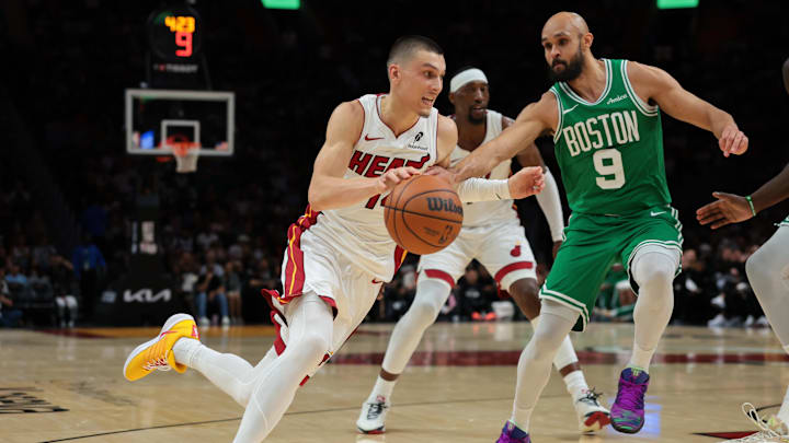 Apr 1, 2026; Miami, Florida, USA; Miami Heat guard Tyler Herro (14) drives to the basket against Boston Celtics guard Derrick White (9) during the second quarter at Kaseya Center. Mandatory Credit: Sam Navarro-Imagn Images