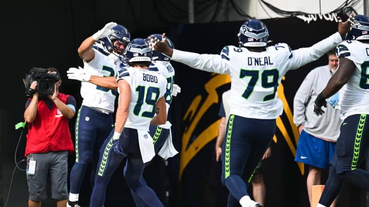 Aug 10, 2024; Inglewood, California, USA; Seattle Seahawks running back George Holani (36) celebrates with teammates after making a touchdown against the Los Angeles Chargers during the second quarter at SoFi Stadium. Mandatory Credit: Jonathan Hui-USA TODAY Sports