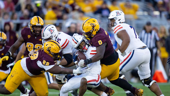 Nov 25, 2023; Tempe, Arizona, USA; Arizona State Sun Devils defensive lineman Dashaun Mallory (0) and defensive lineman C.J. Fite (99) tackle Arizona Wildcats running back Rayshon Luke (21) during the Territorial Cup at Mountain America Stadium. Mandatory Credit: Mark J. Rebilas-USA TODAY Sports