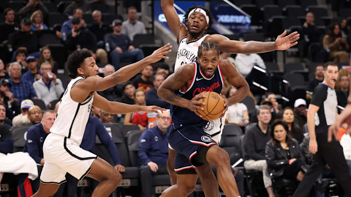 LA Clippers forward Kawhi Leonard (2) drives between Brooklyn Nets guard Reece Beekman (4) and center Day'Ron Sharpe (20) during the first half at Intuit Dome. Mandatory Credit: Kiyoshi Mio-Imagn Images
