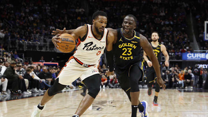 Jan 9, 2025; Detroit, Michigan, USA;  Detroit Pistons guard Malik Beasley (5) dribbles on Golden State Warriors forward Draymond Green (23) in the first half at Little Caesars Arena. Mandatory Credit: Rick Osentoski-Imagn Images