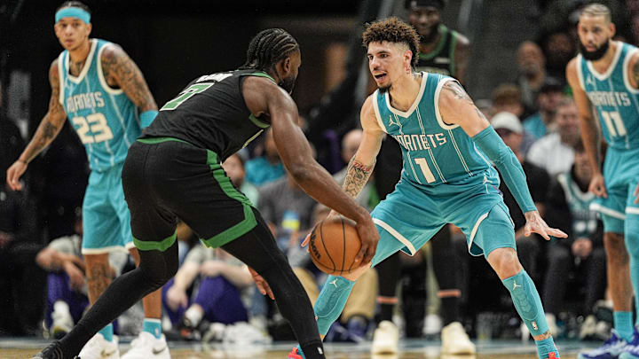 Nov 1, 2024; Charlotte, North Carolina, USA; Charlotte Hornets guard LaMelo Ball (1) on defense against Boston Celtics guard Jaylen Brown (7) during the second half at the Spectrum Center. Mandatory Credit: Jim Dedmon-Imagn Images