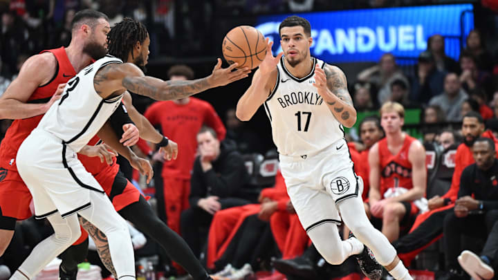 Nov 23, 2025; Toronto, Ontario, CAN;  Brooklyn Nets forward Michael Porter Jr. (17) takes the ball from center Nic Claxton (33) in the second half against the Toronto Raptors at Scotiabank Arena. Mandatory Credit: Dan Hamilton-Imagn Images