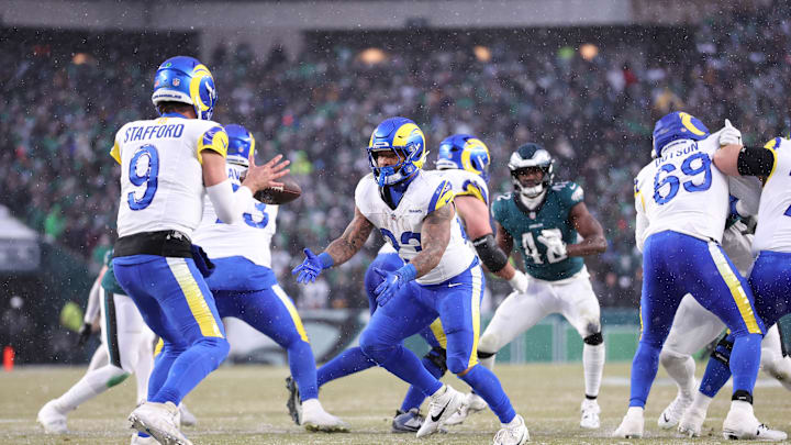 Jan 19, 2025; Philadelphia, Pennsylvania, USA; Los Angeles Rams running back Kyren Williams (23) tosses the ball back to Los Angeles Rams quarterback Matthew Stafford (9) during the second quarter against the Philadelphia Eagles in a 2025 NFC divisional round game at Lincoln Financial Field. Mandatory Credit: Bill Streicher-Imagn Images