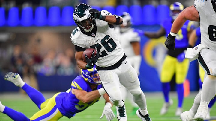 Nov 24, 2024; Inglewood, California, USA; Philadelphia Eagles running back Saquon Barkley (26) runs the ball ahead of Los Angeles Rams linebacker Christian Rozeboom (56).