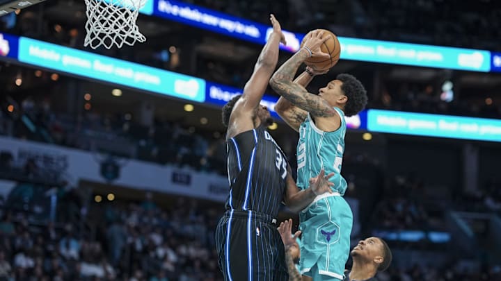 Charlotte Hornets guard Tre Mann (23) goes to the basket against Orlando Magic center Goga Bitadze (35) during the second half at Spectrum Center.