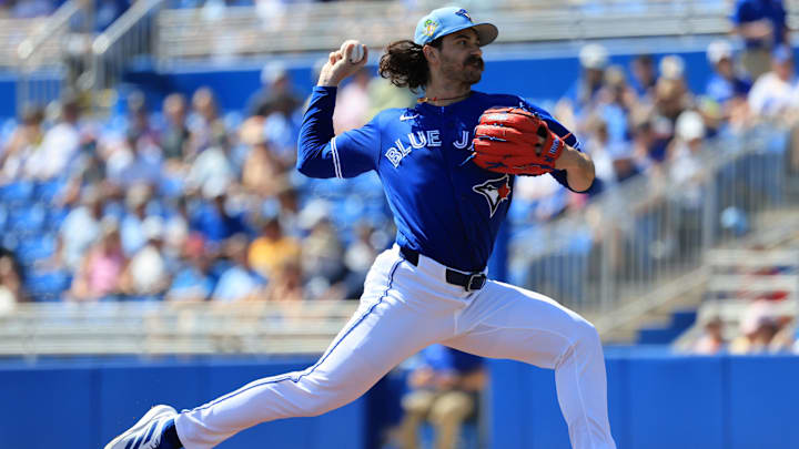 Dylan Cease throws a baseball in a blue Blue Jays unifor