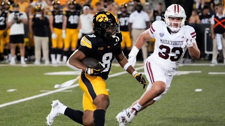 Iowa Hawkeyes running back Terrell Washington Jr. (8) carries the ball as Massachusetts Minutemen defensive lineman Erik Hehl (33) defends Sept. 13, 2025 at Kinnick Stadium in Iowa City, Iowa.