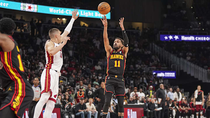 Apr 18, 2025; Atlanta, Georgia, USA; Atlanta Hawks guard Trae Young (11) shoots over Miami Heat guard Tyler Herro (14) during the first half at State Farm Arena. Mandatory Credit: Dale Zanine-Imagn Images