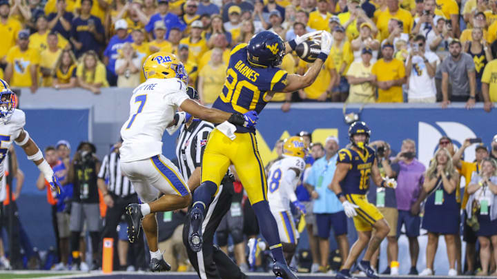 Sep 13, 2025; Morgantown, West Virginia, USA; West Virginia Mountaineers tight end Grayson Barnes (80) catches a pass for a touchdown over Pittsburgh Panthers defensive back Javon McIntyre (7) during the fourth quarter at Milan Puskar Stadium. Mandatory Credit: Ben Queen-Imagn Images
