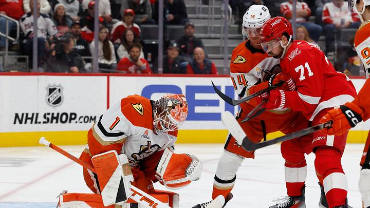 Nov 13, 2025; Detroit, Michigan, USA;  Anaheim Ducks goaltender Lukas Dostal (1) makes the save in front of Detroit Red Wings center Dylan Larkin (71) in the second period at Little Caesars Arena. Mandatory Credit: Rick Osentoski-Imagn Images