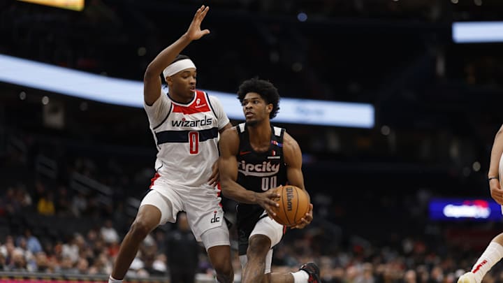 Feb 26, 2025; Washington, District of Columbia, USA; Portland Trail Blazers guard Scoot Henderson (00) drives to the basket as Washington Wizards guard Bilal Coulibaly (0) defends in the first half at Capital One Arena. Mandatory Credit: Geoff Burke-Imagn Images