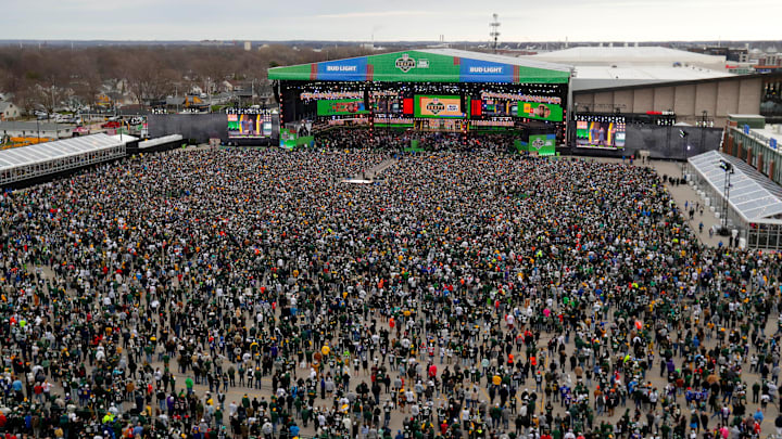 Thousands of people fill the draft theater viewing area at the start of the 2025 NFL Draft outside Lambeau Field in Green Bay, Wis.