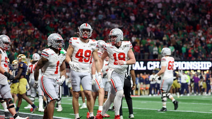 Jan 20, 2025; Atlanta, GA, USA; Ohio State Buckeyes running back Quinshon Judkins (1), tight end Patrick Gurd (49), and quarterback Will Howard (18) celebrate after a touchdown against the Notre Dame Fighting Irish during the second half the CFP National Championship college football game at Mercedes-Benz Stadium. Mandatory Credit: Mark J. Rebilas-Imagn Images