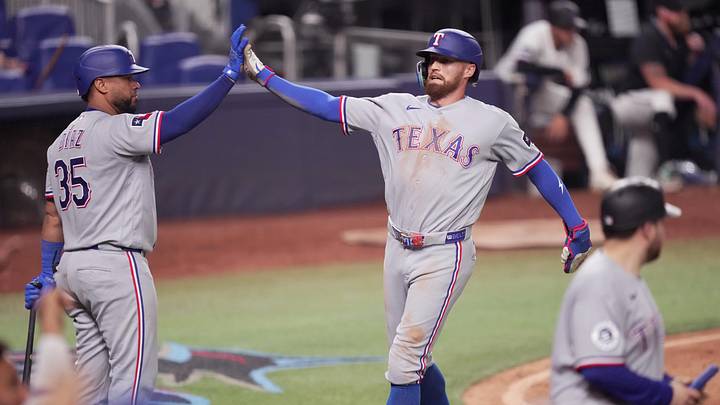 Jun 22, 2026; Miami, Florida, USA;  Texas Rangers right fielder Brandon Nimmo (24) celebrates scoring a run with catcher Elias Díaz (35) in the eighth inning against the Miami Marlins at loanDepot Park. Mandatory Credit: Jim Rassol-Imagn Images