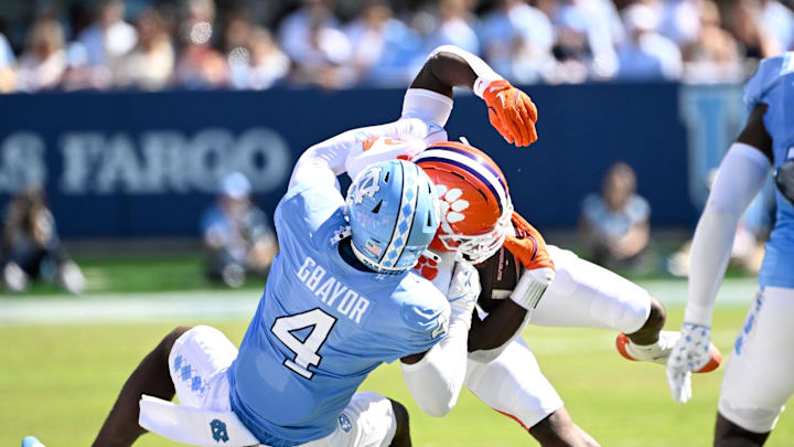 Oct 4, 2025; Chapel Hill, North Carolina, USA; Clemson Tigers running back David Eziomume (24) is tackled by North Carolina Tar Heels linebacker Mikai Gbayor (4) in the second quarter at Kenan Stadium. Mandatory Credit: Bob Donnan-Imagn Images Oct 4, 2025; Chapel Hill, North Carolina, USA; Clemson Tigers running back David Eziomume (24) is tackled by North Carolina Tar Heels linebacker Mikai Gbayor (4) in the second quarter at Kenan Stadium. Mandatory Credit: Bob Donnan-Imagn Images