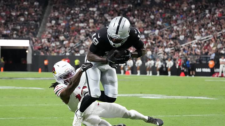 Aug 13, 2026; Paradise, Nevada, USA; Las Vegas Raiders wide receiver Malik Benson (19) carries the ball against Arizona Cardinals cornerback Max Melton (16) in the first half at Allegiant Stadium. Mandatory Credit: Kirby Lee-Imagn Images