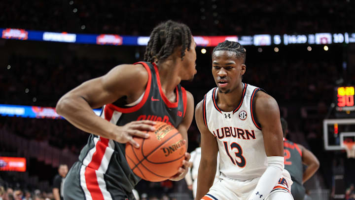 Dec 14, 2024; Atlanta, Georgia, USA; Auburn Tigers guard Miles Kelly (13) guards Ohio State Buckeyes guard Meechie Johnson Jr. (1) during the first half at State Farm Arena. Mandatory Credit: Jordan Godfree-Imagn Images