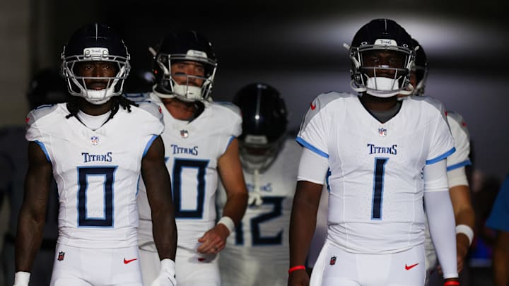 Aug 9, 2025; Tampa, Florida, USA; Tennessee Titans wide receiver Calvin Ridley (0) and quarterback Cameron Ward (1) take the field for warmups before a preseason game against the Tampa Bay Buccaneers at Raymond James Stadium. Mandatory Credit: Nathan Ray Seebeck-Imagn Images