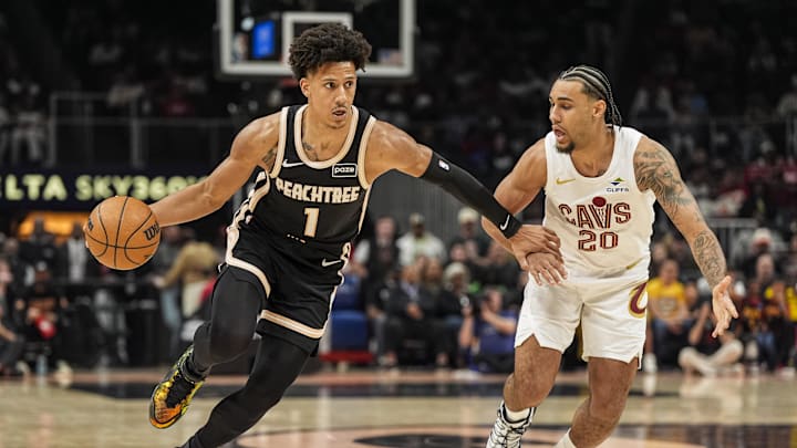 Apr 10, 2026; Atlanta, Georgia, USA; Atlanta Hawks forward Jalen Johnson (1) dribbles against Cleveland Cavaliers guard Jaylon Tyson (20) during the first half at State Farm Arena. Mandatory Credit: Dale Zanine-Imagn Images