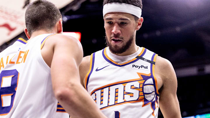 Dec 5, 2024; New Orleans, Louisiana, USA;  Phoenix Suns guard Devin Booker (1) and guard Grayson Allen (8) after a play against the New Orleans Pelicans during the second half  at Smoothie King Center. Mandatory Credit: Stephen Lew-Imagn Images