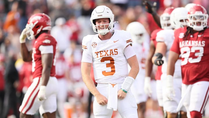 Nov 16, 2024; Fayetteville, Arkansas, USA; Texas Longhorns quarterback Quinn Ewers (3) celebrates after making a final first down to end the game against the Arkansas Razorbacks at Donald W. Reynolds Razorback Stadium. Texas won 20-10. Mandatory Credit: Nelson Chenault-Imagn Images