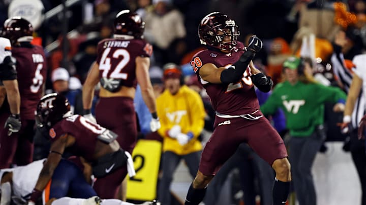 Nov 30, 2024; Blacksburg, Virginia, USA; Virginia Tech Hokies linebacker Caleb Woodson (20) celebrates after a play during the second quarter against the Virginia Cavaliers at Lane Stadium. Mandatory Credit: Peter Casey-Imagn Images