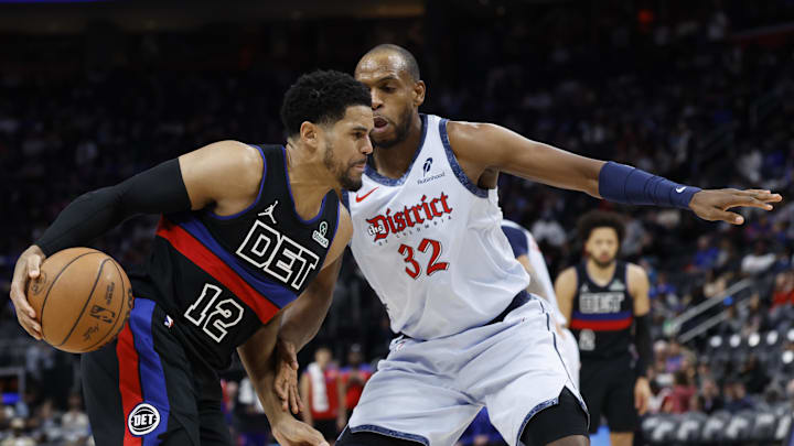Mar 13, 2025; Detroit, Michigan, USA;  Detroit Pistons forward Tobias Harris (12) dribbles defended by Washington Wizards forward Khris Middleton (32) in the second half at Little Caesars Arena. Mandatory Credit: Rick Osentoski-Imagn Images