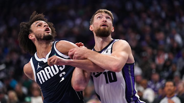 Mar 29, 2024; Sacramento, California, USA; Sacramento Kings forward Domantas Sabonis (10) battles Dallas Mavericks center Dereck Lively II (2).