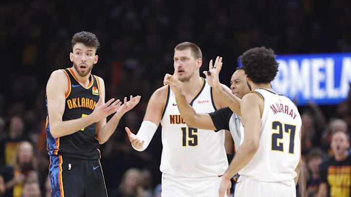 May 5, 2025; Oklahoma City, Oklahoma, USA; Oklahoma City Thunder forward Chet Holmgren (7) and Denver Nuggets center Nikola Jokic (15) react to a play during the second half in game one of the second round for the 2025 NBA Playoffs at Paycom Center. Mandatory Credit: Alonzo Adams-Imagn Images