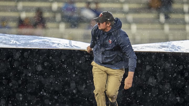 May 19, 2025; Minneapolis, Minnesota, USA; Minnesota Twins grounds crew roll out the on field tarp during the second inning in a game between the Cleveland Guardians and Minnesota Twins at Target Field. Mandatory Credit: Jesse Johnson-Imagn Images