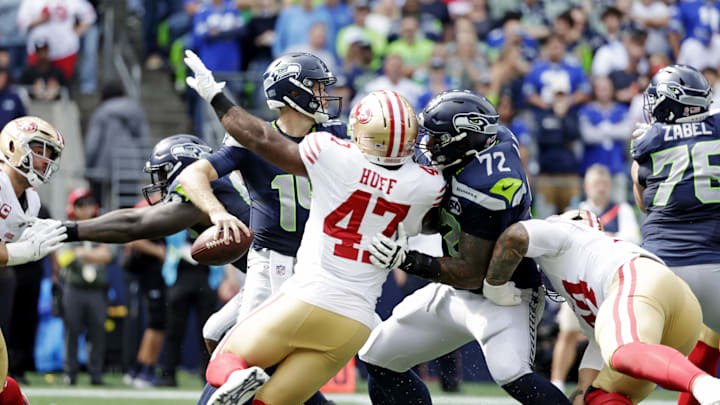 Sep 7, 2025; Seattle, Washington, USA; Seattle Seahawks quarterback Sam Darnold (14) looks to make a pass against San Francisco 49ers during the first half at Lumen Field. Mandatory Credit: Joe Nicholson-Imagn Images
