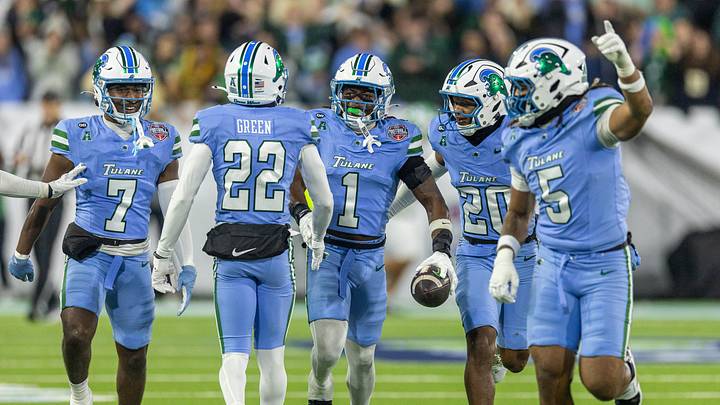 Dec 5, 2025; New Orleans, LA, USA; Tulane Green Wave safety Jack Tchienchou (1) reacts to intercepting a pass against North Texas Mean Green during the second half in the 2025 American Championship at Yulman Stadium. Mandatory Credit: Stephen Lew-Imagn Images Dec 5, 2025; New Orleans, LA, USA; Tulane Green Wave safety Jack Tchienchou (1) reacts to intercepting a pass against North Texas Mean Green during the second half in the 2025 American Championship at Yulman Stadium. Mandatory Credit: Stephen Lew-Imagn Images