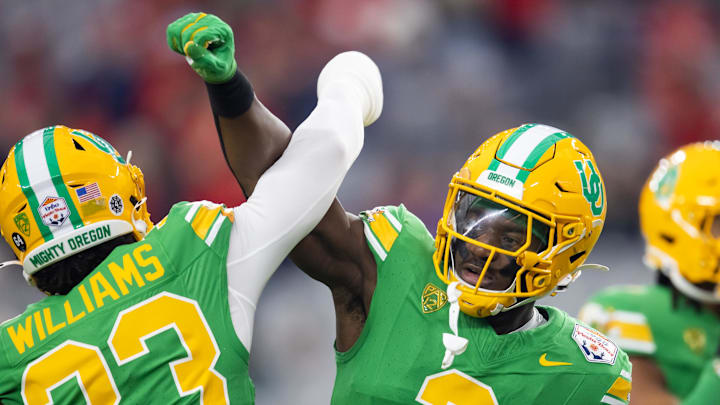 Jan 1, 2024; Glendale, AZ; Oregon Ducks linebacker Jeffrey Bassa (2) with defensive back Evan Williams (33) celebrate.