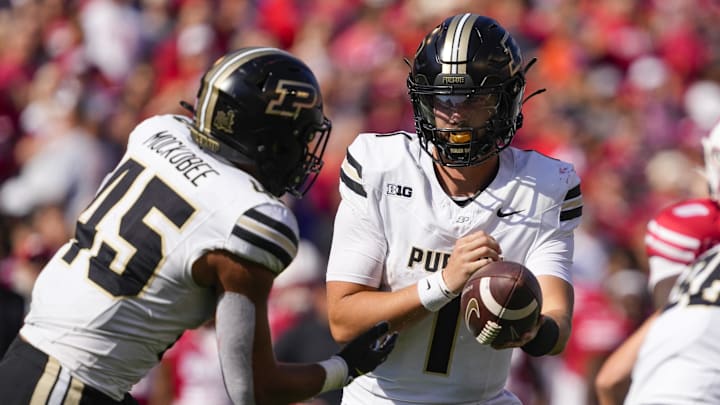 Purdue Boilermakers quarterback Hudson Card (1) hands the football off to running back Devin Mockobee (45) 