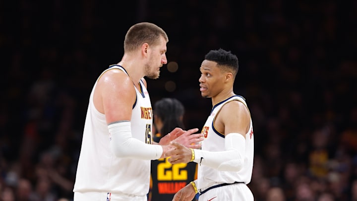 May 5, 2025; Oklahoma City, Oklahoma, USA; Denver Nuggets center Nikola Jokic (15) and guard Russell Westbrook (4) talk a break in play against the Oklahoma City Thunder during the second half during game one of the second round for the 2025 NBA Playoffs at Paycom Center. Mandatory Credit: Alonzo Adams-Imagn Images