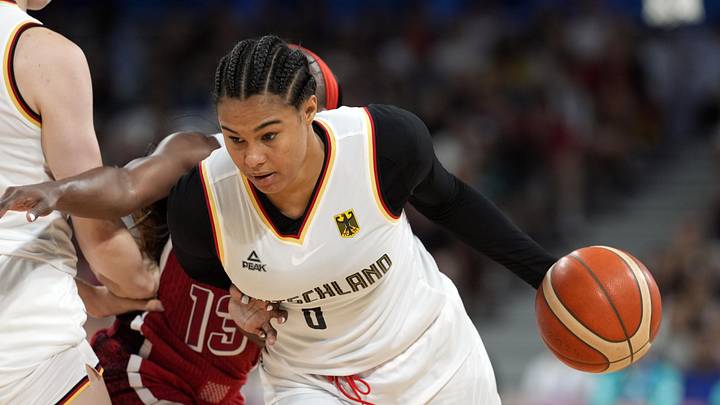 Aug 4, 2024; Villeneuve-d'Ascq, France; Germany forward Satou Sabally (0) controls the ball against United States guard Jackie Young (13) in the second half in a women’s group C game during the Paris 2024 Olympic Summer Games at Stade Pierre-Mauroy. Mandatory Credit: John David Mercer-Imagn Images Aug 4, 2024; Villeneuve-d'Ascq, France; Germany forward Satou Sabally (0) controls the ball against United States guard Jackie Young (13) in the second half in a women’s group C game during the Paris 2024 Olympic Summer Games at Stade Pierre-Mauroy. Mandatory Credit: John David Mercer-Imagn Images