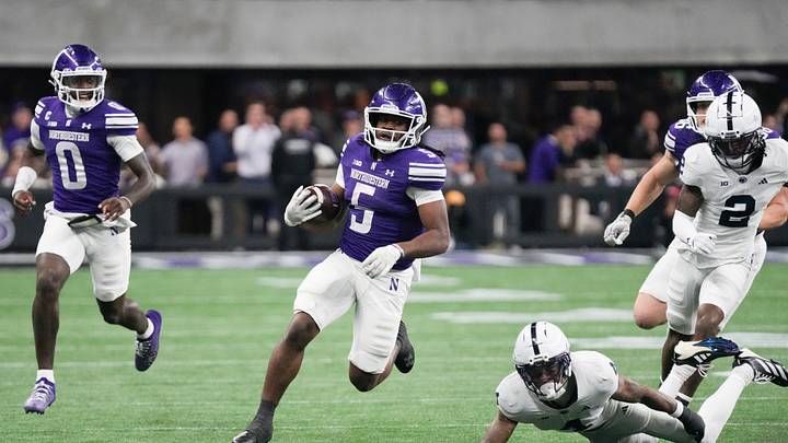 Northwestern Wildcats running back Caleb Komolafe (5) runs the ball against the Penn State Nittany Lions during the second half at New Ryan Field. Mandatory Credit: David Banks-Imagn Images Northwestern Wildcats running back Caleb Komolafe (5) runs the ball against the Penn State Nittany Lions during the second half at New Ryan Field. Mandatory Credit: David Banks-Imagn Images