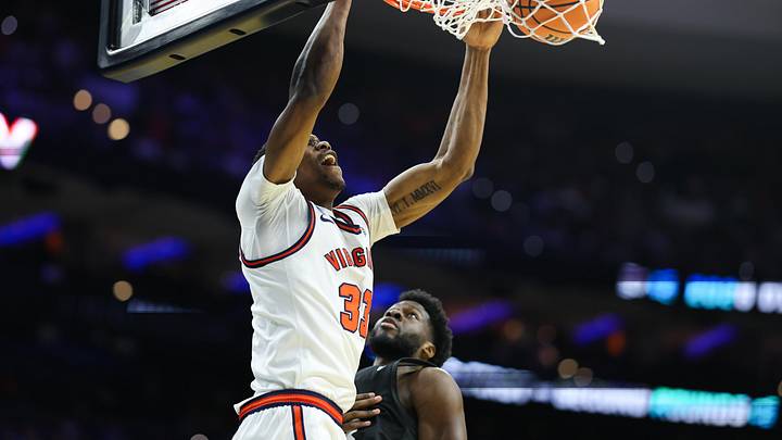 Mar 20, 2026; Philadelphia, PA, USA; Virginia Cavaliers center Ugonna Onyenso (33) dunks during the first half against the Wright State Raiders during a first round game of the men's 2026 NCAA Tournament at Xfinity Mobile Arena. Mandatory Credit: Bill Streicher-Imagn Images