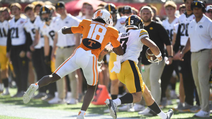 Tennessee defensive back Rickey Gibson III (18) pushes Iowa wide receiver Kaleb Brown (3) out of