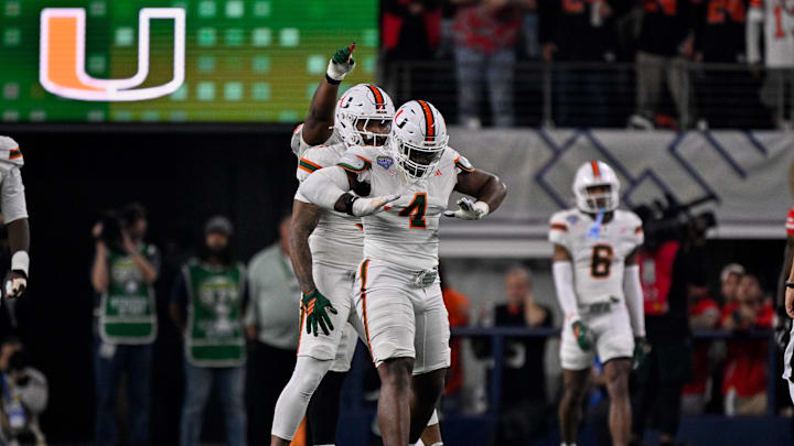 Dec 31, 2025; Arlington, TX, USA; Miami Hurricanes defensive lineman Rueben Bain Jr. (4) and defensive lineman Akheem Mesidor (3) celebrates after sacking Ohio State Buckeyes quarterback Julian Sayin (not pictured) during the 2025 Cotton Bowl and quarterfinal game of the College Football Playoff at AT&T Stadium. Mandatory Credit: Jerome Miron-Imagn Images