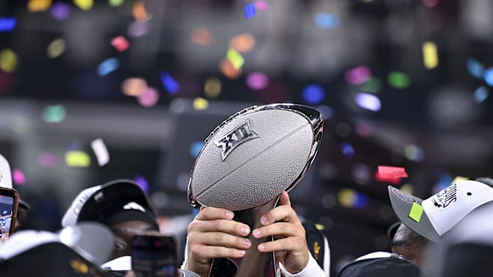Dec 7, 2024; Arlington, TX, USA; The Arizona State Sun Devils team celebrate with the trophy after the Sun Devils defeat the Iowa State Cyclones and win the 2024 Big 12 Championship at AT&T Stadium. Mandatory Credit: Jerome Miron-Imagn Images