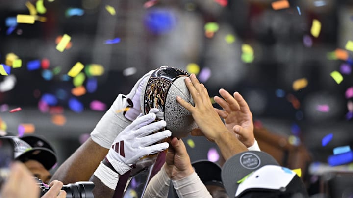 Dec 7, 2024; Arlington, TX, USA; The Arizona State Sun Devils team celebrate with the trophy after the Sun Devils defeat the Iowa State Cyclones and win the 2024 Big 12 Championship at AT&T Stadium. Mandatory Credit: Jerome Miron-Imagn Images
